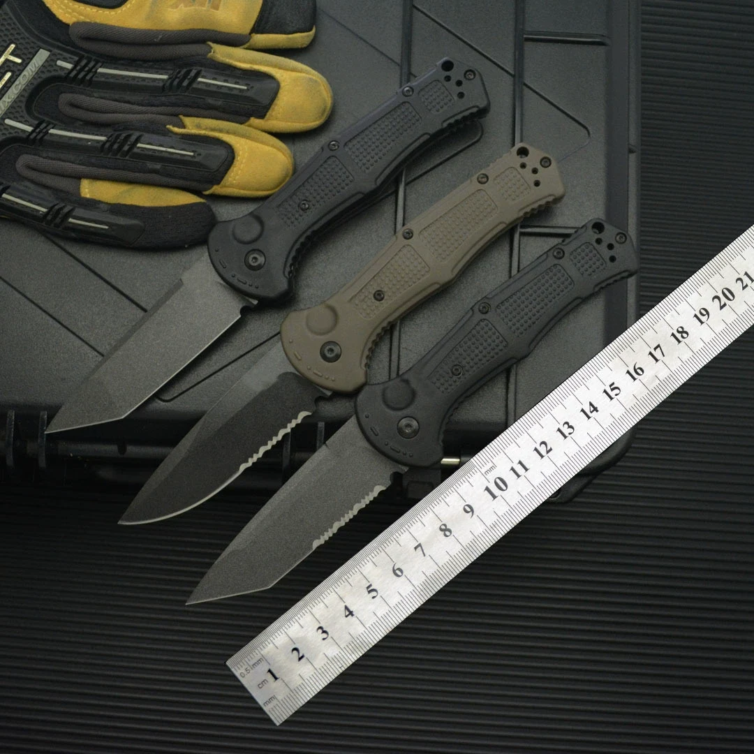 Black and army green 8Cr13MoV folding knives shown open beside a ruler