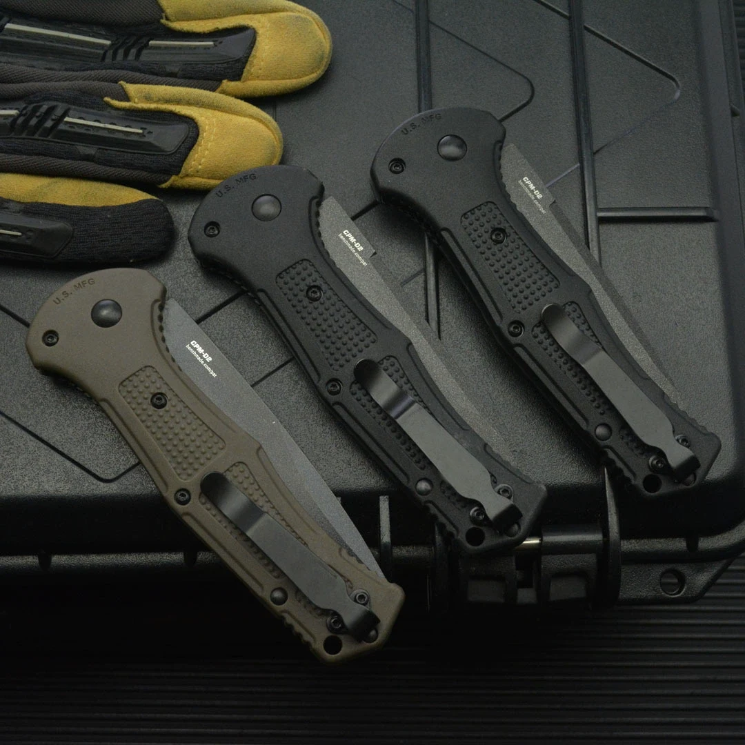 Back view of black and army green folding knives with pocket clips