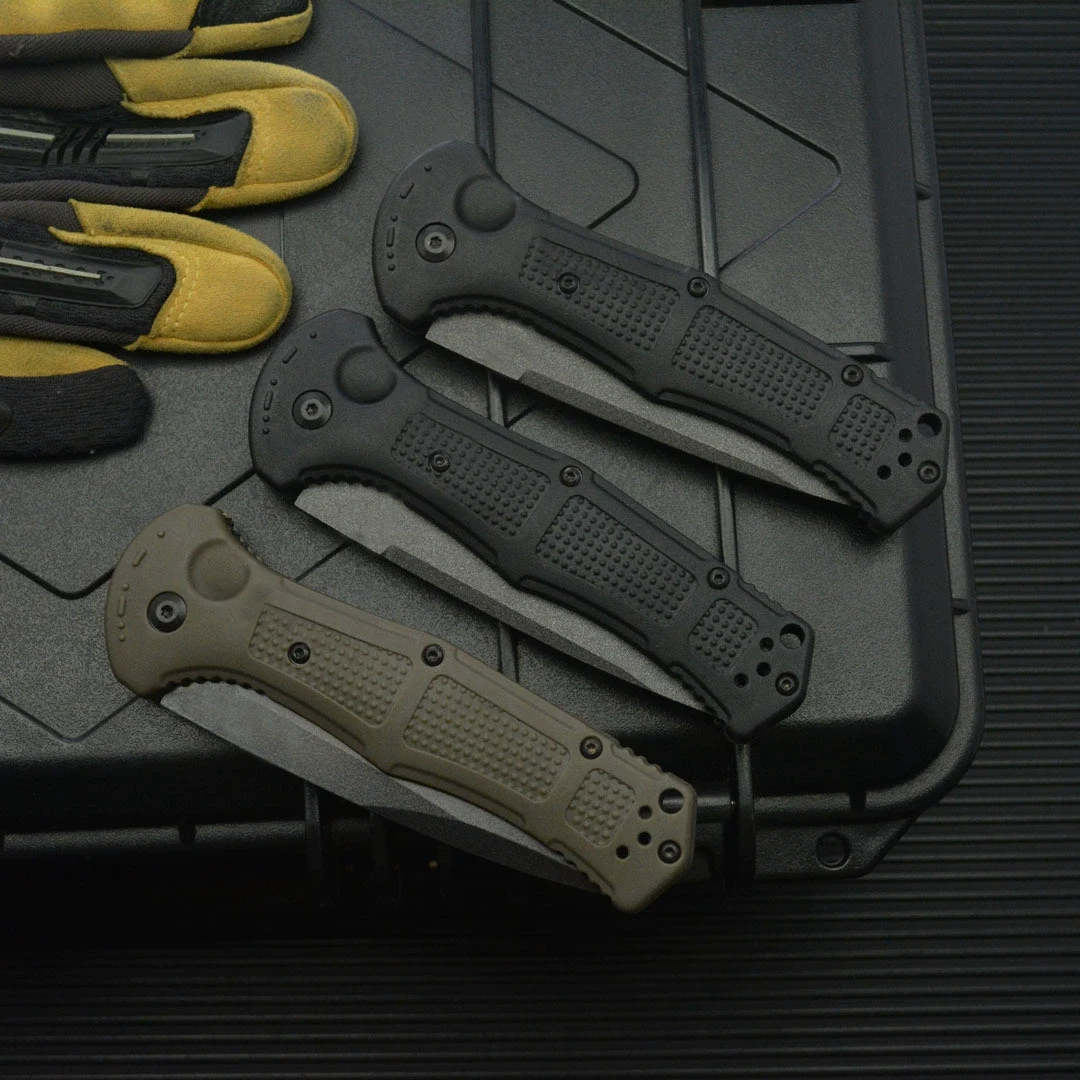 Black and army green folding knives shown in the folded position