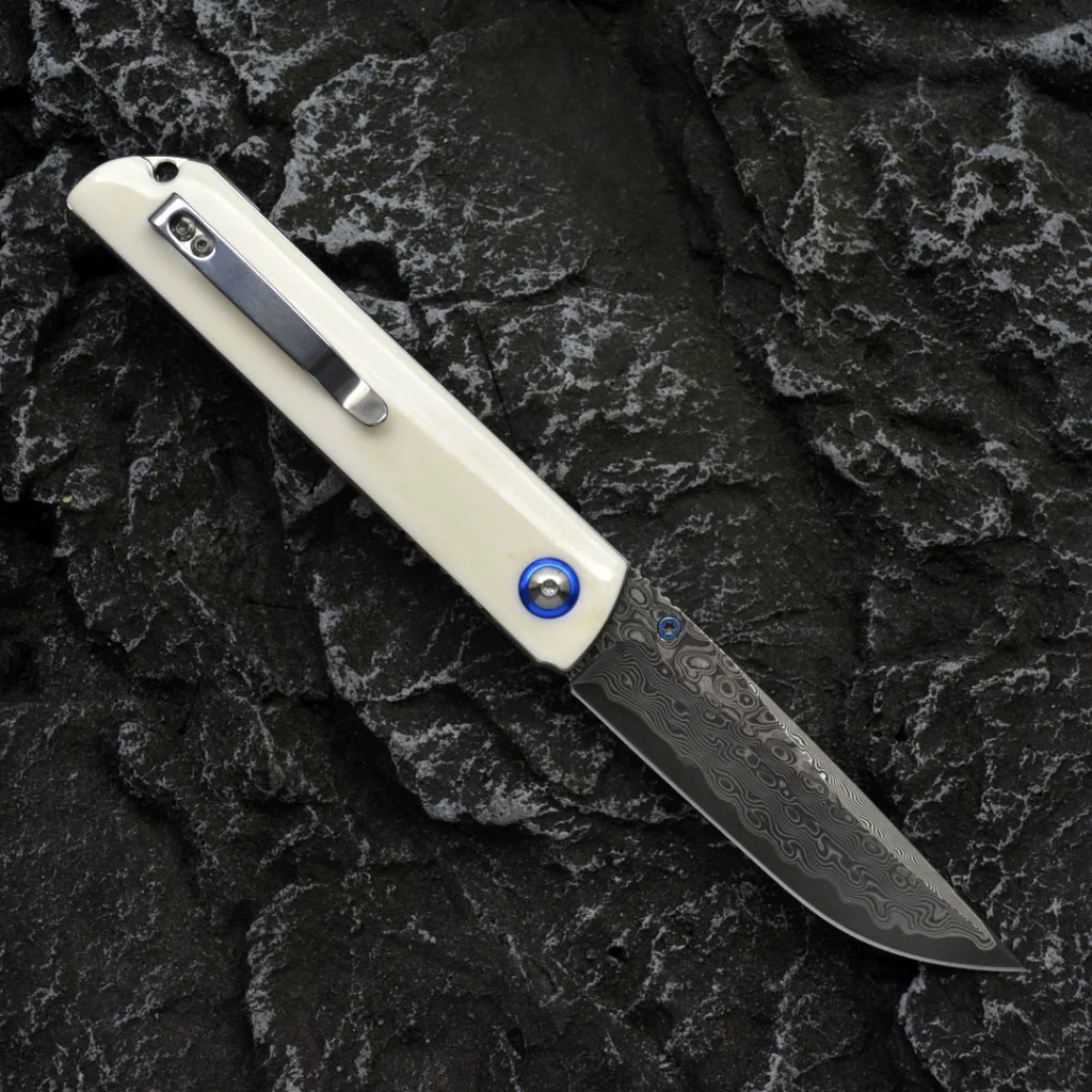 Open bone-handle Damascus folding knife with pocket clip visible