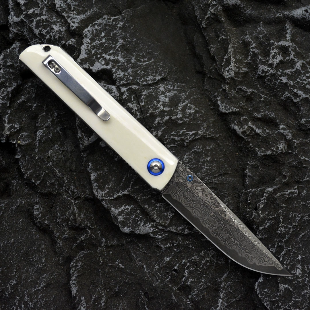 Open bone-handle Damascus folding knife with pocket clip visible