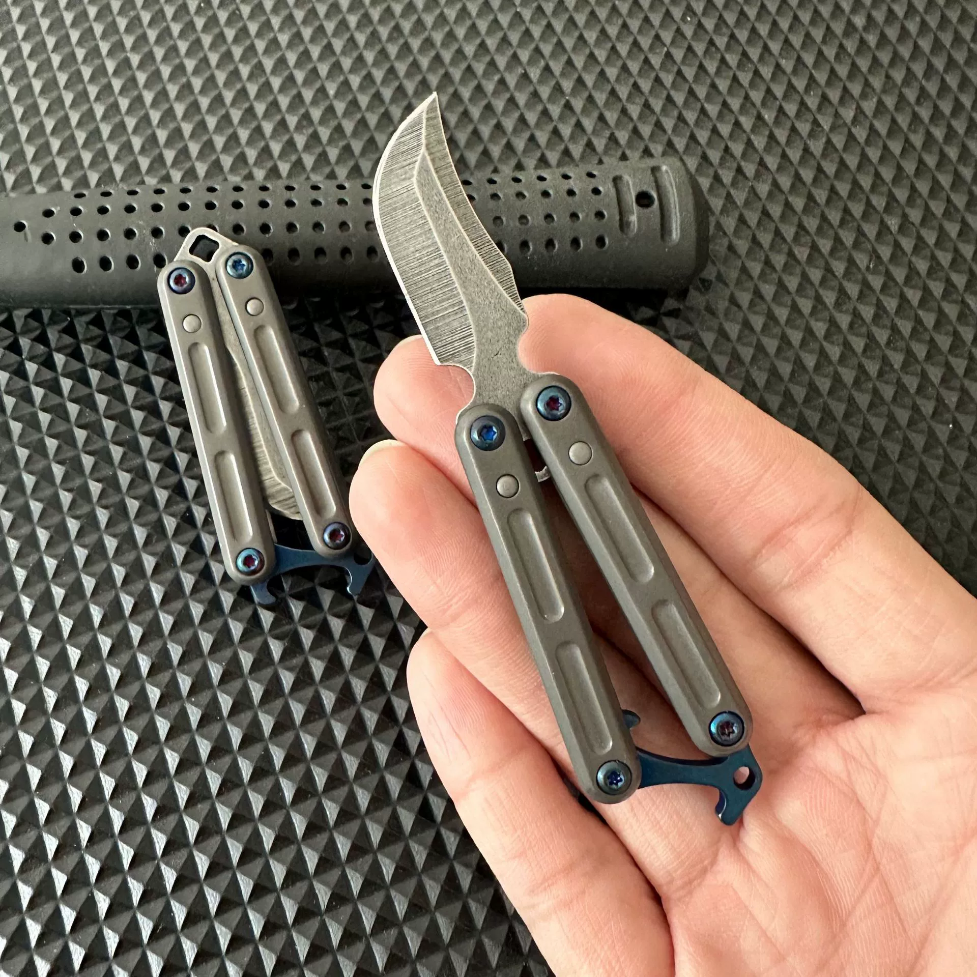 Mini stainless steel butterfly knife shown folded
